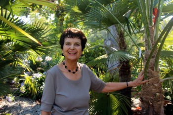 Edith with palm Edith Bergstrom: Showcasing the whole world (of palms) in her back yard